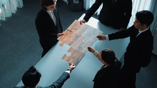 Top view of skilled businesspeople hand bring and fill the last jigsaw piece together. Group of project manager complete puzzle or solving problem. Unity, teamwork, successful project. Directorate.