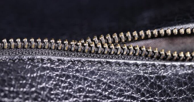 details of a natural black leather bag after prolonged use, details and pieces of natural leather used for the production of items, cracked