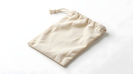 Fototapeta premium A simple, plain, light-colored fabric drawstring pouch lying on a white background, ready for packaging or storage.