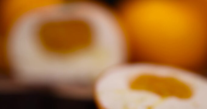creamy mousse with fruit filling of oranges, delicate creamy mousse with citrus center and glossy coating on the background of whole cakes with high detail and realistic surface.