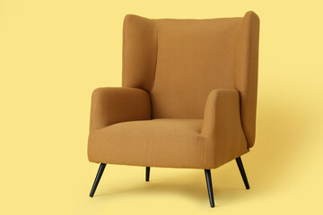 Fototapeta premium Cozy armchair on yellow background