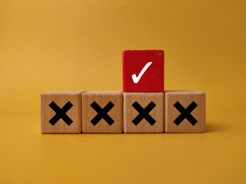 A red block showing a white check mark is placed above a row of blocks marked with black crosses