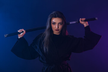 Beautiful young woman with katana on dark color background © Pixel-Shot