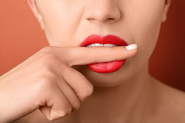 Naklejka premium Woman with red lips on color background, closeup