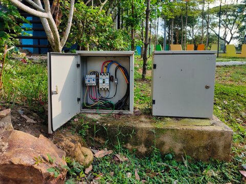 Two electrical boxes, one of which is open, show that the wires in the playground are very dangerous to visitors, especially children.
