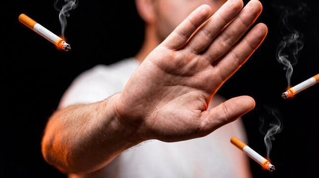 Man refusing cigarettes with stop hand gesture anti smoking