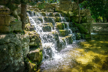 Scenic waterfalls and cascades within Confederation Park in Stratford, Ontario, creating a tranquil natural feature surrounded by lush greenery and historic park landscaping. © Mehdi