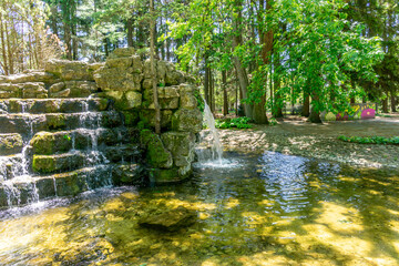 Scenic waterfalls and cascades within Confederation Park in Stratford, Ontario, creating a tranquil natural feature surrounded by lush greenery and historic park landscaping. © Mehdi