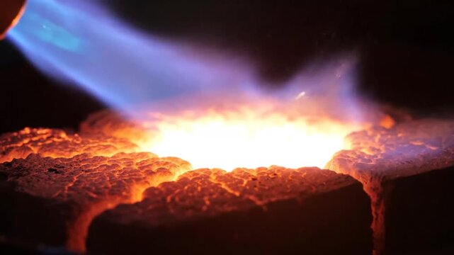 Intense Molten Metal Pouring with Torch Flame and Sparks.