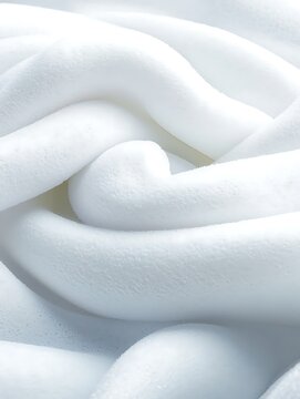 Close-up of white soft twisted fabric with smooth gentle curves and plush texture