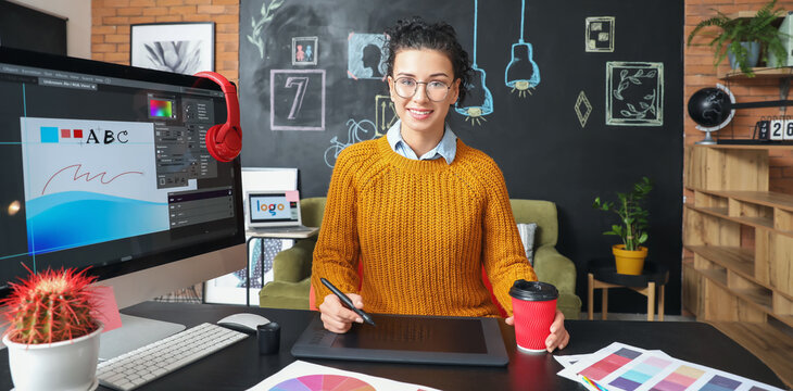 Young female designer working in office