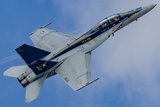 F/A-18 Super Hornet fighter jet climbing in blue sky