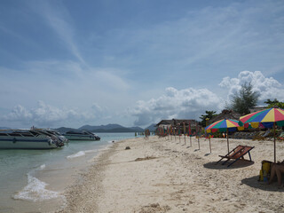 Fototapeta premium Colorful Beach Umbrellas and Speedboats on Khai Nai Cat Island Thailand
