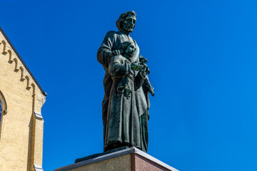 Fototapeta premium Historic Saint Joseph's statue at the Catholic Church in Stratford, Ontario, established in the 1860s with traditional ecclesiastical architecture and spiritual importance to the local community.