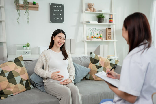 Asian pregnant woman consult with doctor at a maternal health center. 