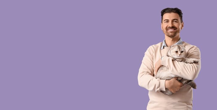 Smiling man cuddling adorable scottish fold cat, pet ownership and animal companionship, isolated on purple background