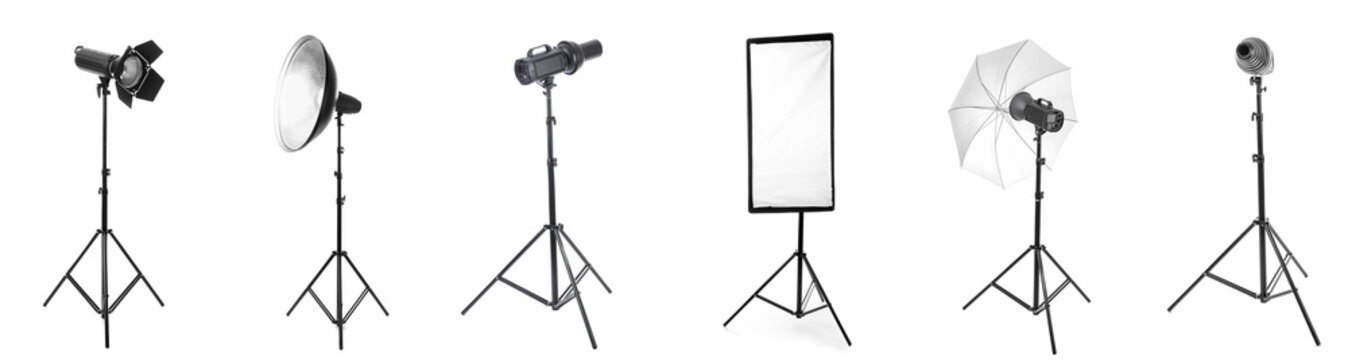 Professional photography studio lighting equipment collection with various light modifiers and stands isolated on white background