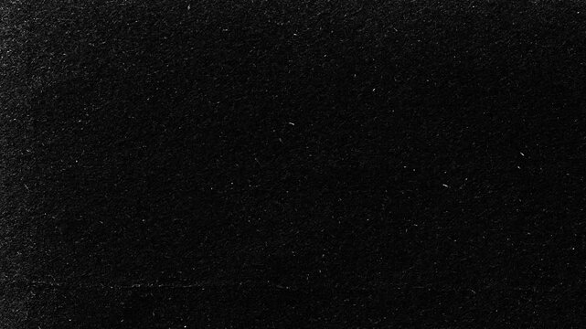 Vintage Film Grain Texture.Black grunge background with dust and scratches. Perfect for retro stop motion and video effects.