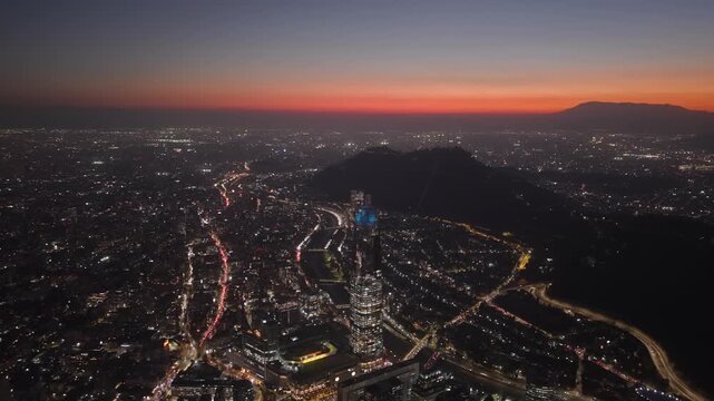 Aerial Dolly Out Sunset Night Gran Torre Santiago and City Lights Chile, Illuminated Downtown