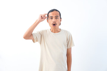 Fototapeta premium Young Asian man in a shirt, with a shocked face expression. Isolated on a white background