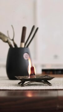 Vertical video. Incense burning. Spiritual practice. Tools for meditation yoga mental health smoke fire destress oriental atmosphere.