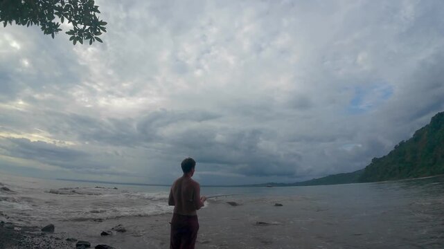 Man Fishing From Tropical Beach On Costa Rica Coast