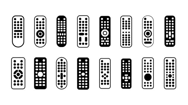 A collection of remote controls on a plain surface with various designs