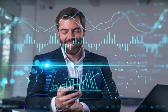 Smiling businessman talking holding using smartphone typing at office workplace with notebook. Concept of distant work, business education. Forex market stock and charts, graphs.