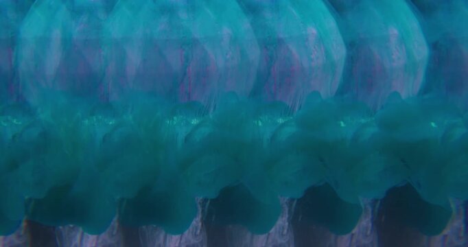 Paint spill. Blur kaleidoscope. Blue dye pouring on pink diamond sphere. Doubled lens effect pigment water abstract black background.