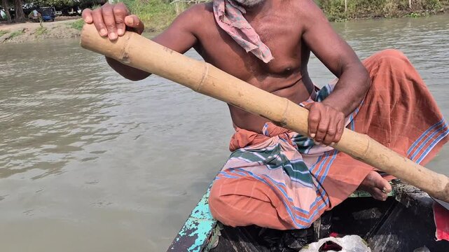 Close Up of Boatman Hands Rowing Wooden Boat with Bamboo Oar