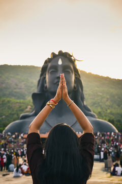 Indian woman offering prayers before the Adiyogi Shiva statue at Chikkaballapur, Karnataka, a renowned spiritual destination near Bangalore dedicated to yoga, meditation and inner transformation