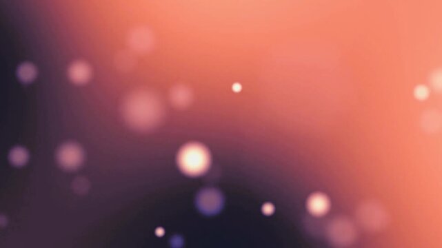 Abstract blurred background with soft light particles and bokeh effect in orange and purple tones