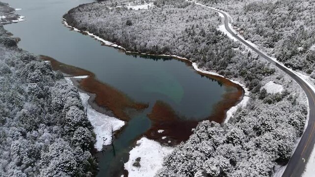Aerial Drone Establishing Flight over Snowy Guillelmo Lake and Route 40 Patagonia Argentina