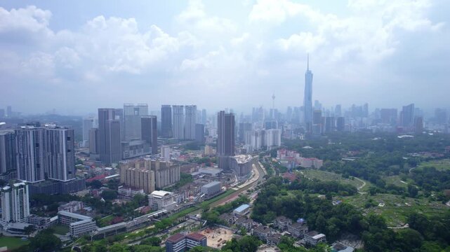 Wide aerial drone shot capturing the expansive Kuala Lumpur skyline with Merdeka 118 towering above the modern urban landscape.