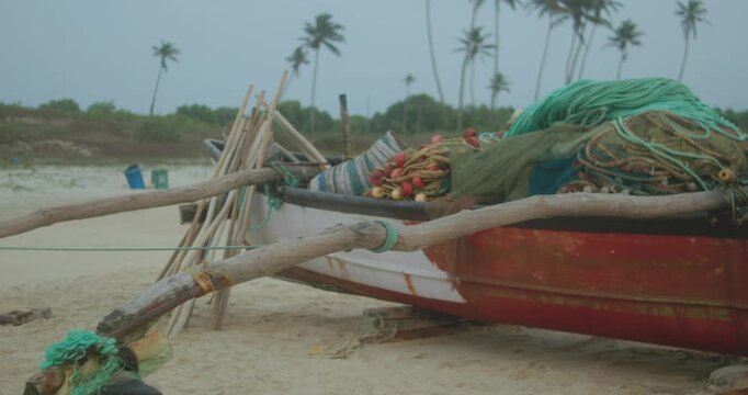 Camera slowly pulls back from fishing boat loaded with tropical gear.