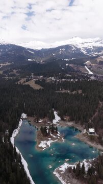 Lake Cauma Switzerland Swiss Alps region Caumasee nature, aerial drone vertical video reel