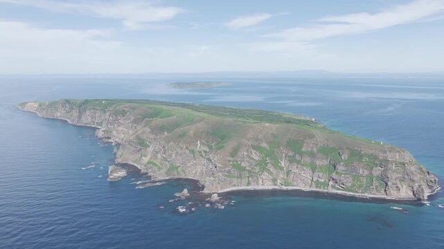 Aerial drone footage of rocky island cliffs and sea in Hokkaido, Japan