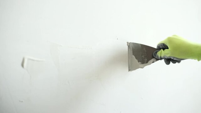 Worker Applies Wall Putty With A Spatula For Wall Preparation Before Painting
