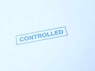 Fototapeta premium A stamped official document, with a blue CONTROLLED mark