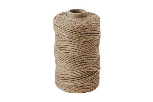 A single spool of thick natural brown jute twine rope wound tightly into a cylinder shape standing upright against a solid black background