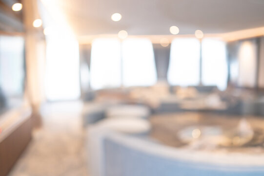 Abstract blurred living room with soft couch and wide window. Blur modern lounge interior space. Use for background or backdrop in a cozy lifestyle concept
