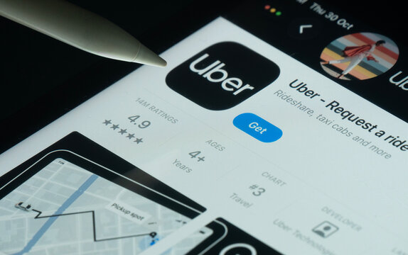 Dhaka, Bangladesh- 30 Oct 2025: Uber app on a iPad screen with a pen pointing at the install option.