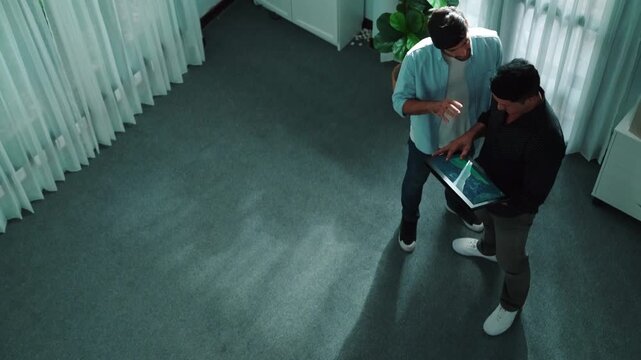Top view of business man walking to investor while holding tablet and looking at financial statistic. Leader joining and giving advise about increase stock market chart display on tablet. Convocation.