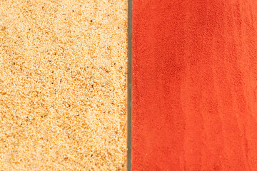 Fototapeta premium Contrast background pattern of organic white sesame seeds and vibrant red paprika powder. Top view texture of oriental spices for food design layout