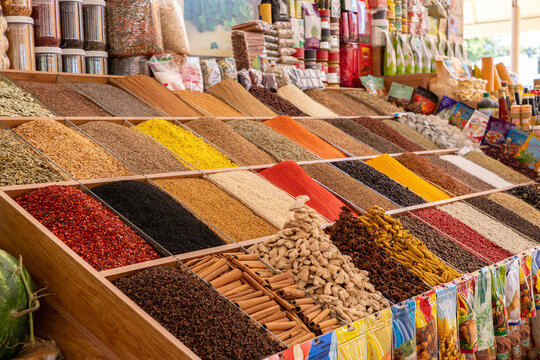 Vibrant assortment of traditional spices and herbs displayed in rows at an oriental bazaar. Authentic Central Asian culinary and food market concept