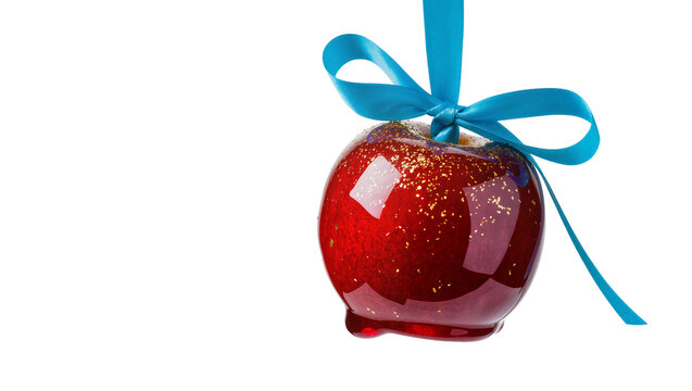 Shiny red candy apple with gold glitter and blue ribbon, isolated on transparent background