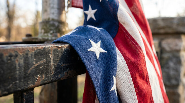 Close Up View Of Folded American Flag Lying On Weathered Surface For 4th Of July