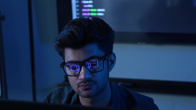 Close-up of male programmer wearing glasses with reflection of financial data chart and coding, Concept of data analysis, software engineering, cybersecurity, stock market trading and business network