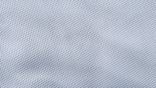 White mesh fabric texture background, close-up of breathable athletic garment material