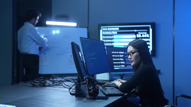 Programmer professional female working on software development, Asian IT developer coding for SaaS platform and cybersecurity network, Modern technology and computer programming business concept
